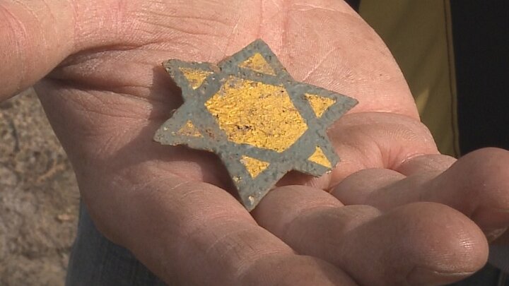 Hand holding a six-sided star